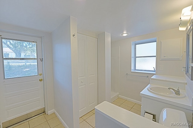 bathroom with tile patterned flooring, vanity, and plenty of natural light