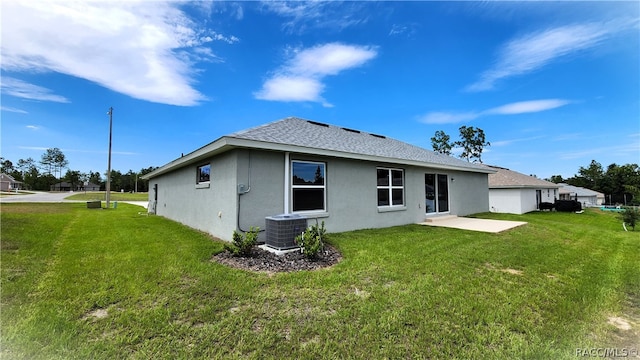 back of property featuring a yard, a patio, and central AC unit