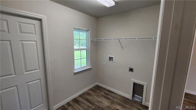 washroom with hookup for an electric dryer, dark wood-type flooring, hookup for a washing machine, and a textured ceiling