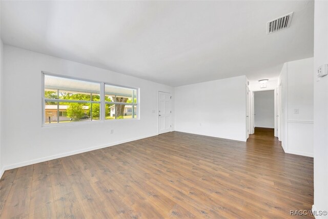 7 N Adams St, Beverly Hills, FL 34465 - empty room featuring dark wood-style floors and baseboards