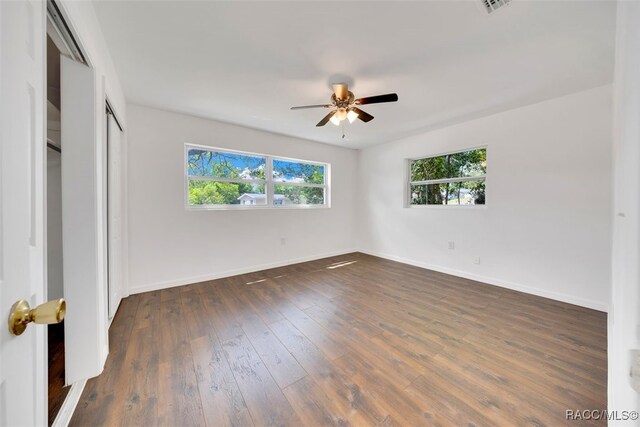 7 N Adams St, Beverly Hills, FL 34465 - unfurnished bedroom with dark wood-style flooring, a closet, and a ceiling fan