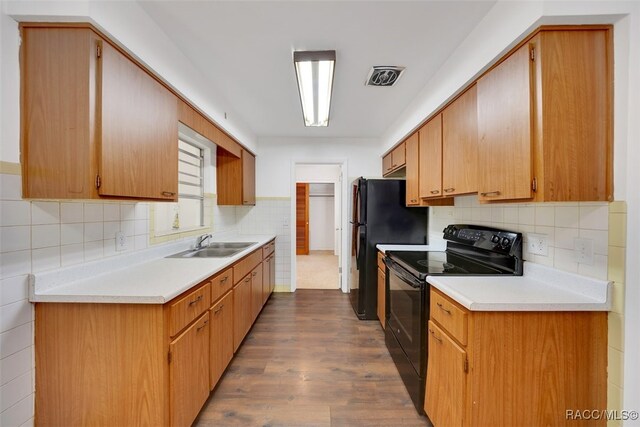 7 N Adams St, Beverly Hills, FL 34465 - kitchen featuring black / electric stove, light countertops, dark wood finished floors, and tasteful backsplash