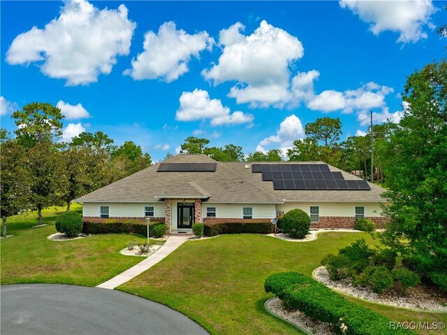 1200 N Annapolis Ave, Hernando, FL 34442 - ranch-style home featuring a front lawn, solar panels, and brick siding