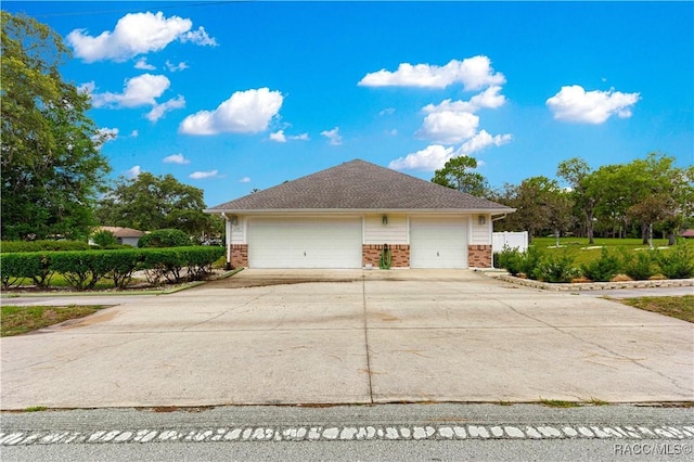 1200 N Annapolis Ave, Hernando, FL 34442 - view of side of home with brick siding, driveway, and a garage