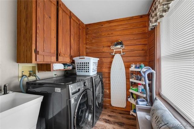 10718 W Dunnellon Rd, Crystal River, FL 34428 - washroom featuring washer and clothes dryer, wood finished floors, and cabinet space