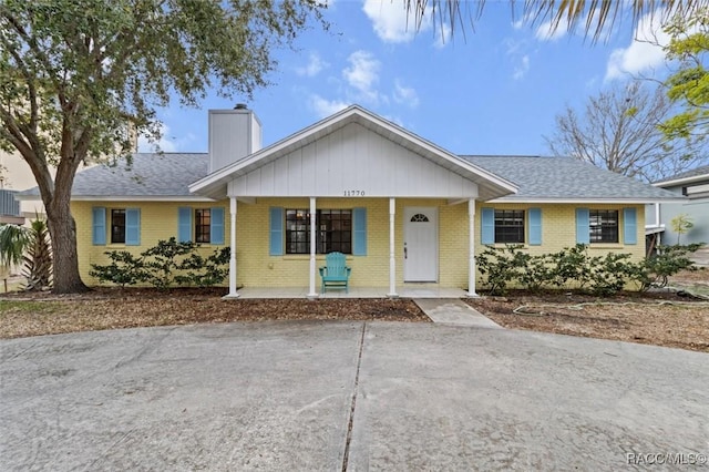 single story home featuring covered porch