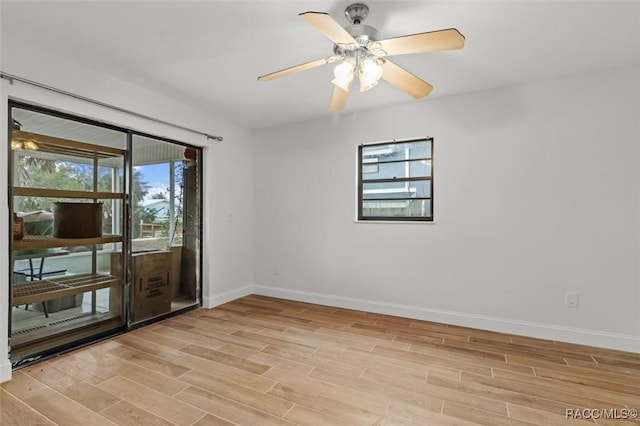 empty room featuring light hardwood / wood-style flooring and ceiling fan