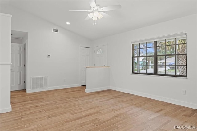 spare room featuring ceiling fan, lofted ceiling, and light hardwood / wood-style floors