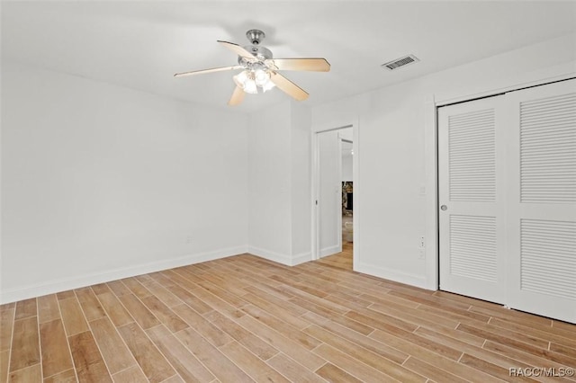 unfurnished bedroom with ceiling fan and light wood-type flooring