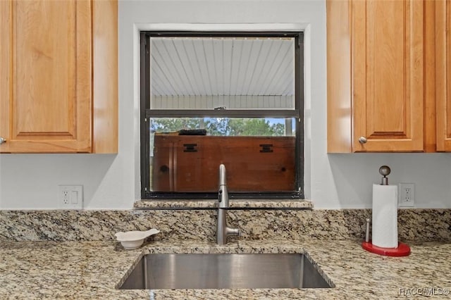 room details featuring sink and light stone counters