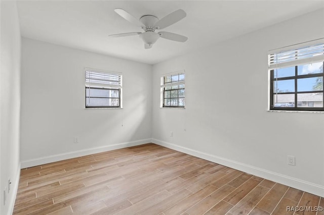 empty room featuring ceiling fan and light hardwood / wood-style floors