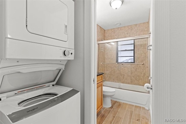 washroom featuring stacked washer and clothes dryer