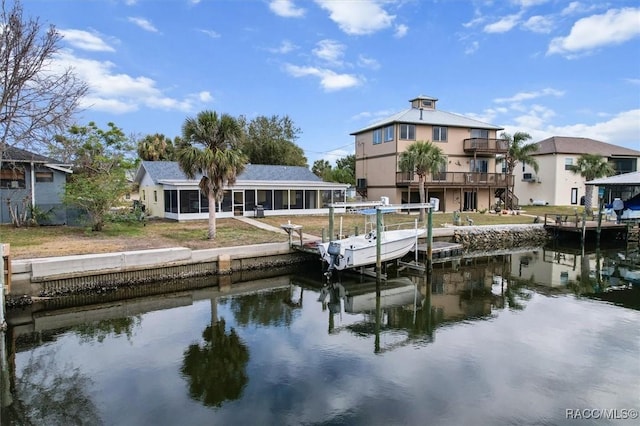 view of dock with a balcony and a water view