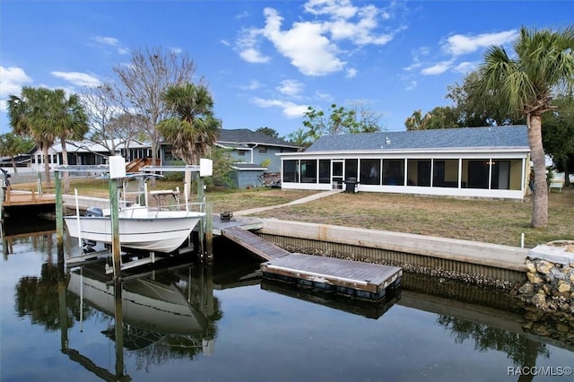 dock area featuring a water view and a lawn