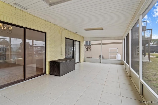 unfurnished sunroom featuring a notable chandelier