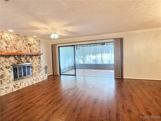 unfurnished living room with ceiling fan, crown molding, hardwood / wood-style floors, a textured ceiling, and a fireplace