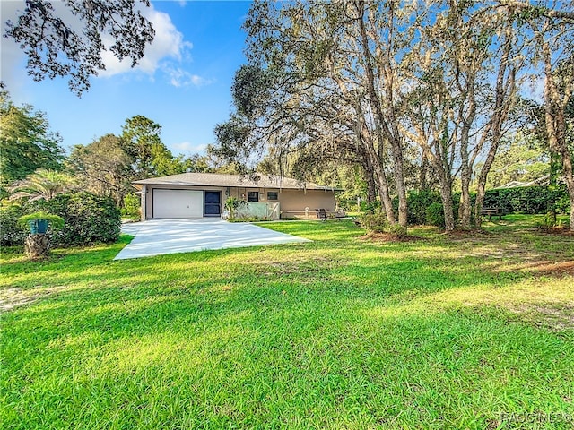 view of front of property with a garage and a front yard