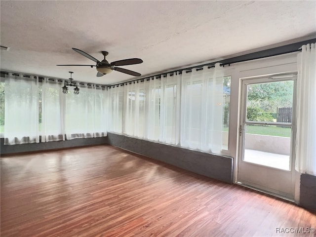 unfurnished sunroom featuring ceiling fan