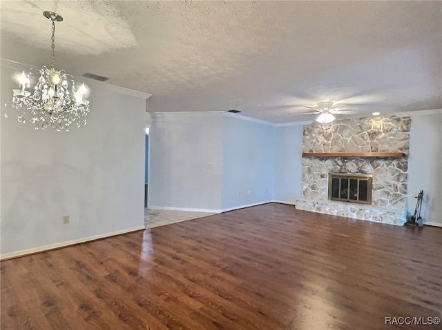 unfurnished living room featuring a stone fireplace, crown molding, a textured ceiling, and hardwood / wood-style flooring