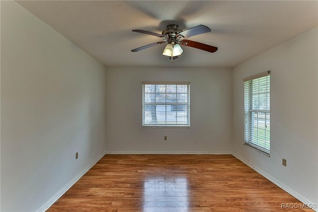 spare room featuring ceiling fan and light hardwood / wood-style flooring