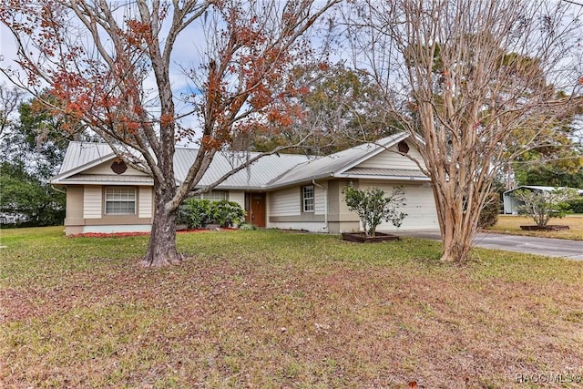 single story home featuring a garage and a front yard