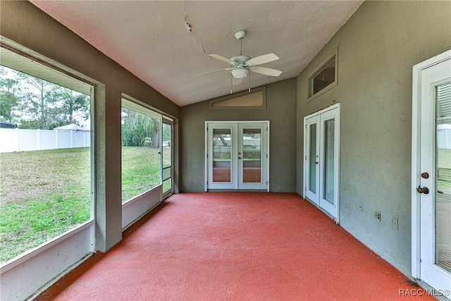 unfurnished sunroom with ceiling fan, french doors, and vaulted ceiling