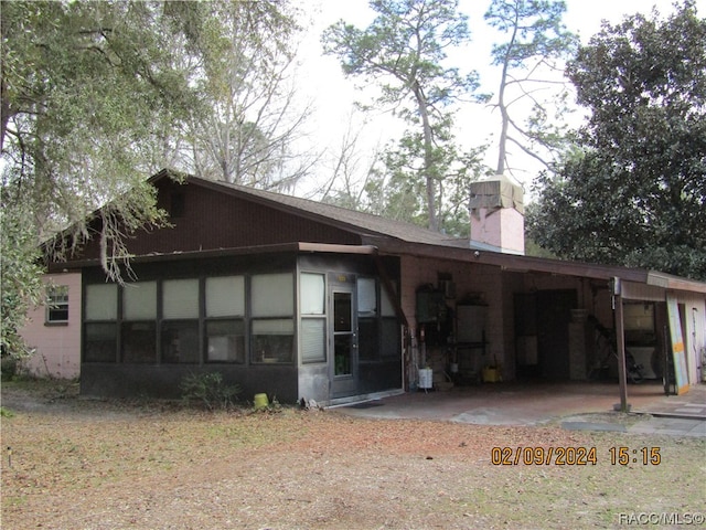 rear view of property with a carport