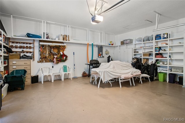 garage with a garage door opener and electric panel