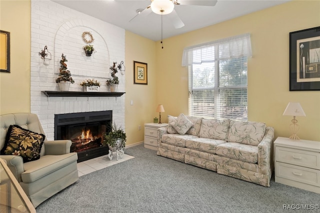 carpeted living room with a ceiling fan and a brick fireplace