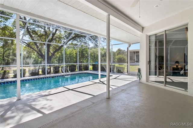 pool featuring a lanai, a ceiling fan, and a patio