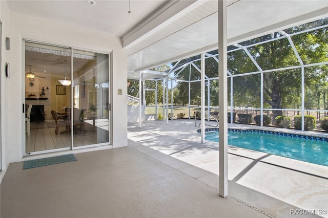 outdoor pool featuring a lanai, ceiling fan, and a patio area