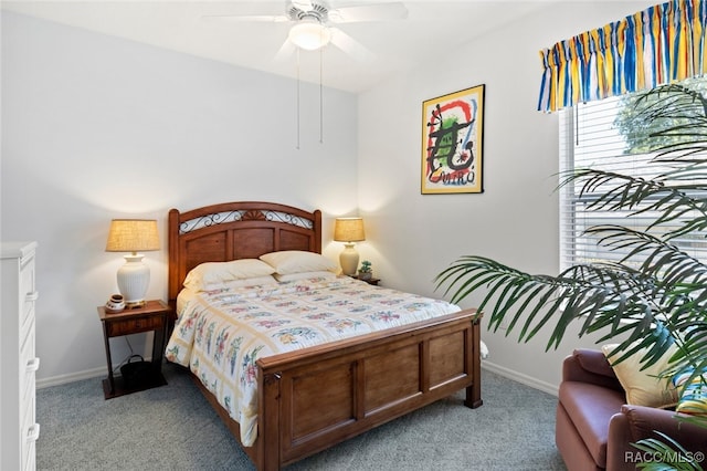 bedroom with a ceiling fan, baseboards, and light carpet