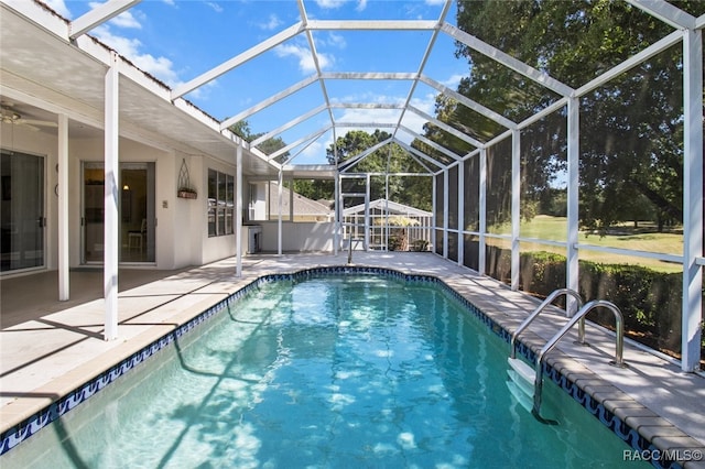 outdoor pool with glass enclosure and a patio