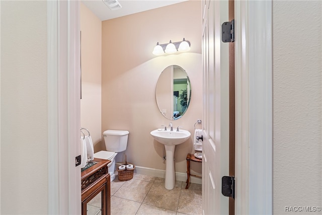 bathroom with tile patterned flooring, toilet, and sink