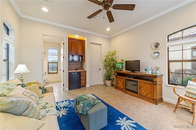 living room featuring ceiling fan, light tile patterned floors, and ornamental molding