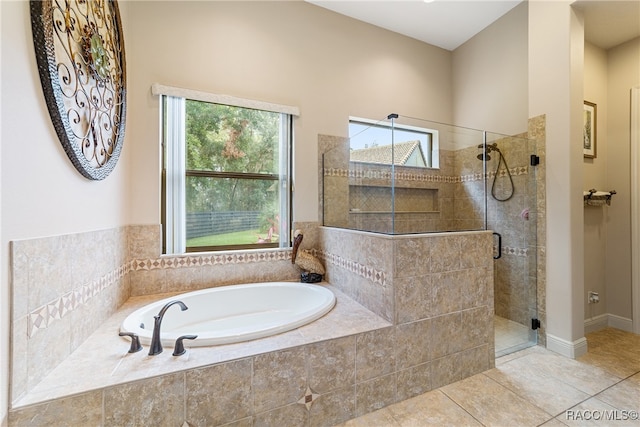 bathroom with tile patterned flooring and separate shower and tub