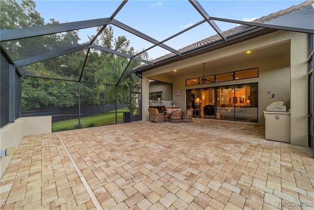 view of patio featuring an outdoor hangout area and glass enclosure