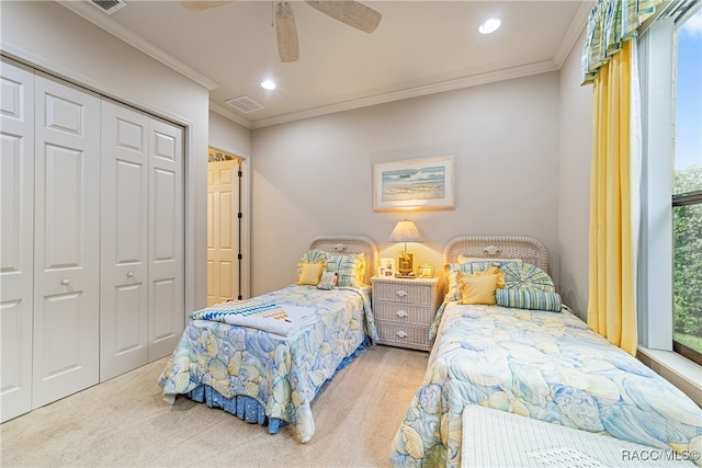 carpeted bedroom with multiple windows, ceiling fan, a closet, and ornamental molding