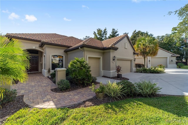 mediterranean / spanish-style home with a garage