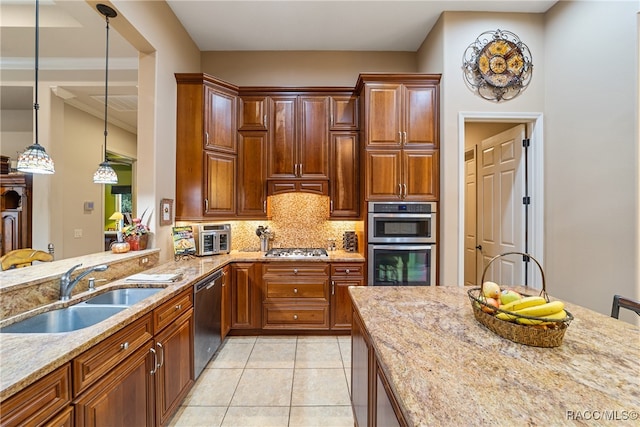 kitchen featuring light tile patterned flooring, light stone countertops, sink, and stainless steel appliances