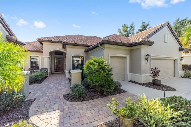 mediterranean / spanish-style home with a garage