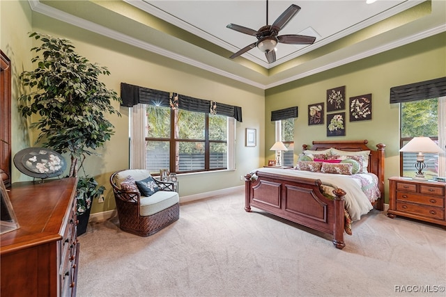 carpeted bedroom with ceiling fan, ornamental molding, and multiple windows