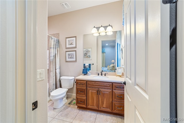 bathroom featuring tile patterned floors, vanity, and toilet