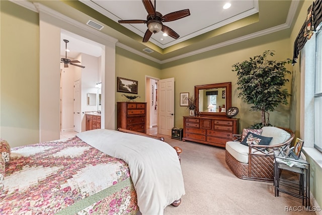 bedroom with ensuite bathroom, crown molding, ceiling fan, and light colored carpet