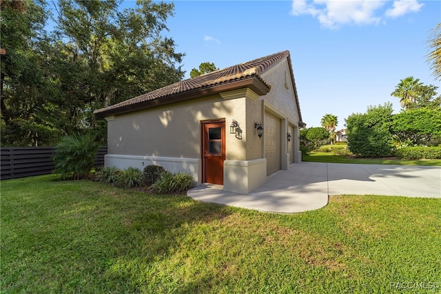 view of side of home featuring a yard and a garage