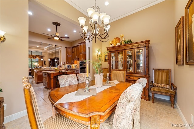 tiled dining room featuring ceiling fan with notable chandelier and crown molding