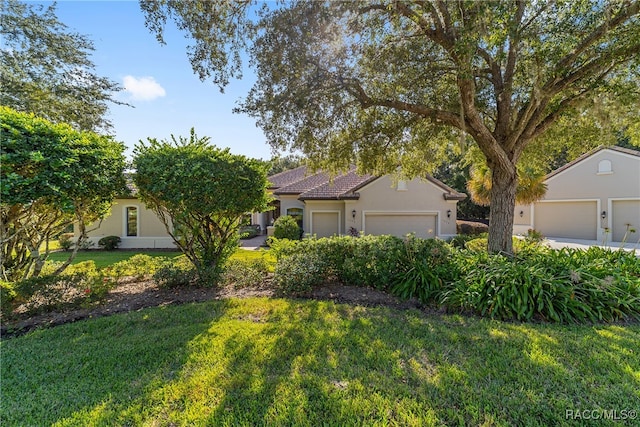 view of front of property with a front yard and a garage