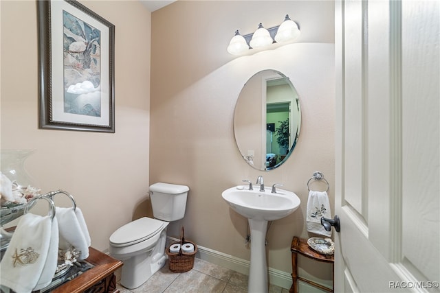 bathroom with tile patterned flooring, toilet, and sink