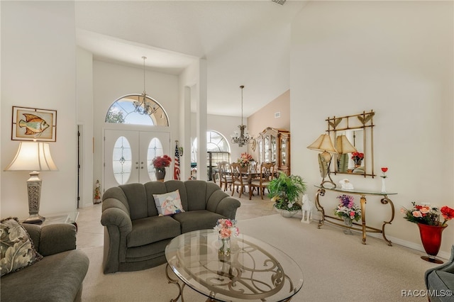 living area featuring an inviting chandelier, a high ceiling, and carpet floors