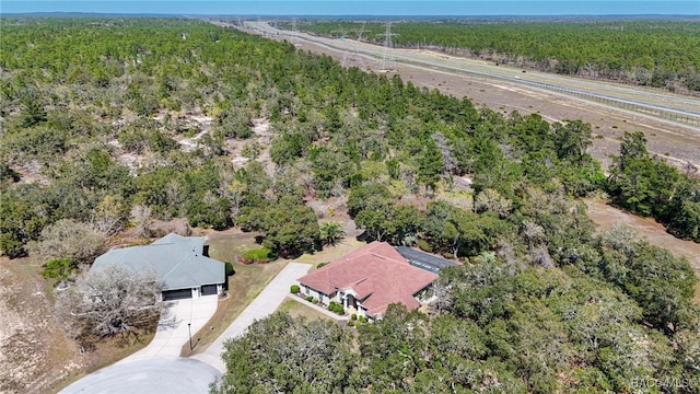 aerial view featuring a wooded view